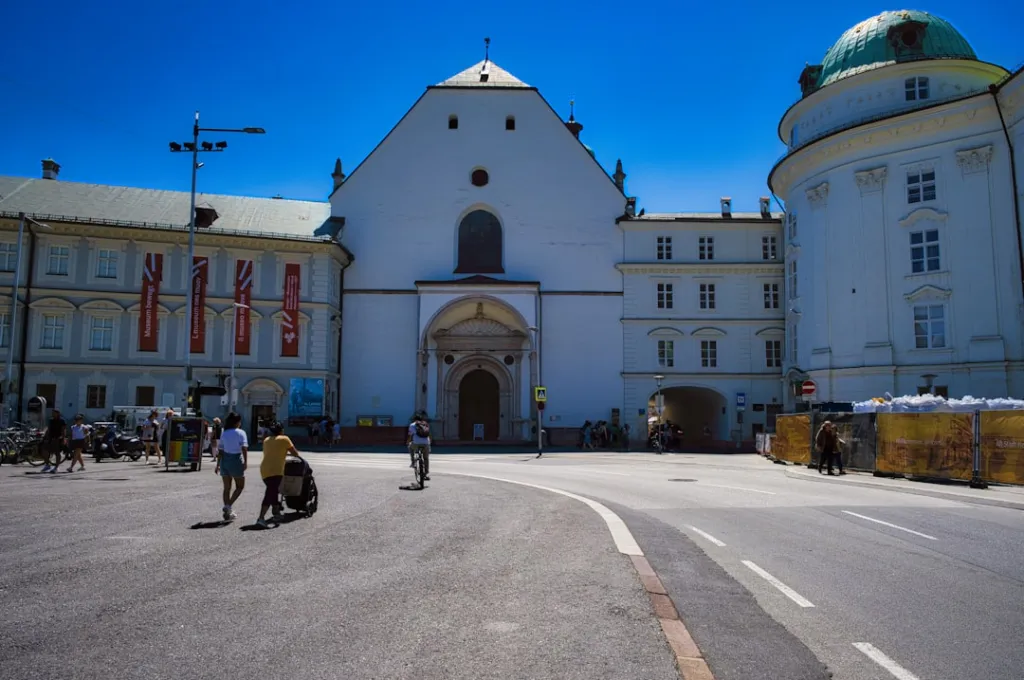 Historic white church facade in a sunny european city square.